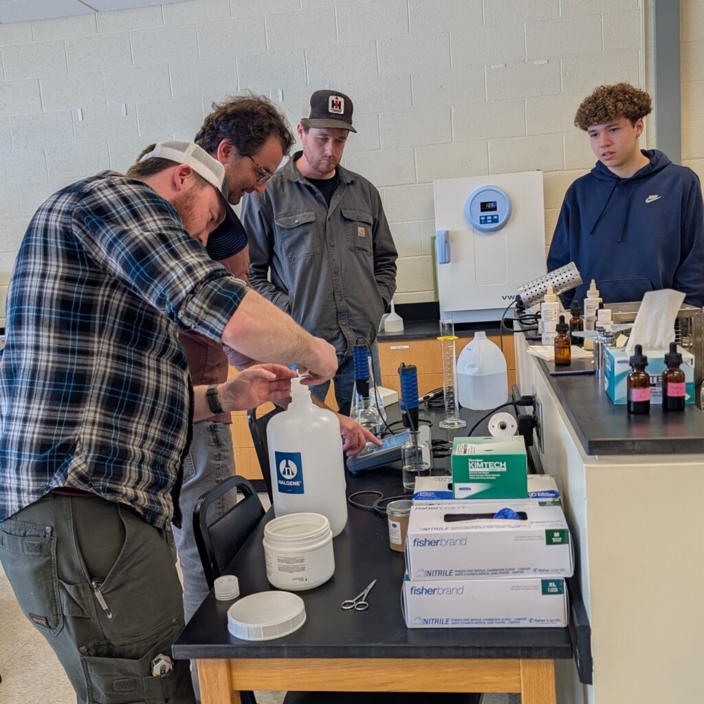 Four training attendees at a lab bench.